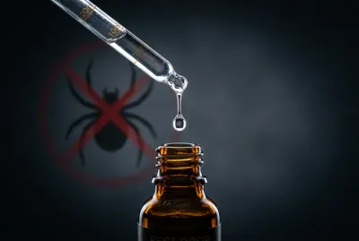 Goutte d'huile essentielle avec symbole anti-araignée pour répulsif